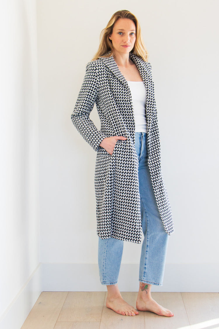 The Lily is a full body pocketed coat, lined with a silken interior and a gorgeous soft brush houndstooth finish. Striking and elegant, this highlight piece is a seasonal must-have. 

