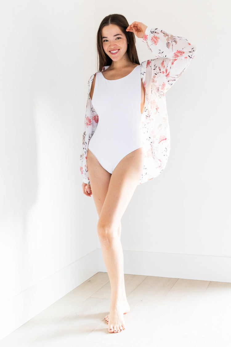The Camryn sheer pull-on shirt features a beautiful floral pattern on lightweight fabric, making it an ideal swimwear cover-up. With a matching bottom available, this shirt creates a stunning set that is perfect for any beach or poolside occasion.

