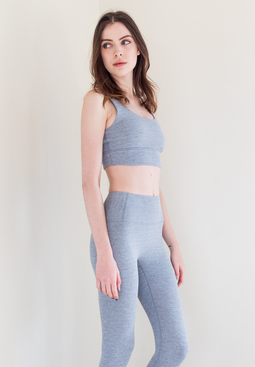 The Royal Ribbed Bra Top in Ash is a stylish and supportive athletic bra top that is perfect for any workout or active lifestyle. It features a grey heather finish, a secure fit, and anti-pill technology, ensuring that it stays looking and feeling great wear after wear.
