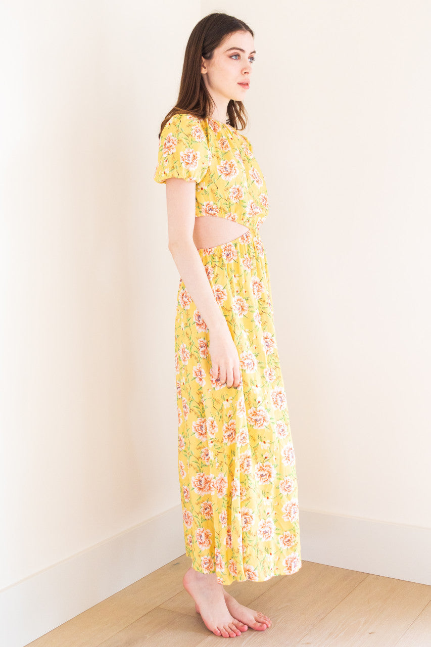 This stunning maxi dress features split sides for added movement and a touch of edge. It comes in a versatile black colour and a bold yellow floral print, perfect for making a statement at any summer occasion. Made from high-quality fabric, this dress exudes sophistication and is sure to elevate your summer wardrobe.
