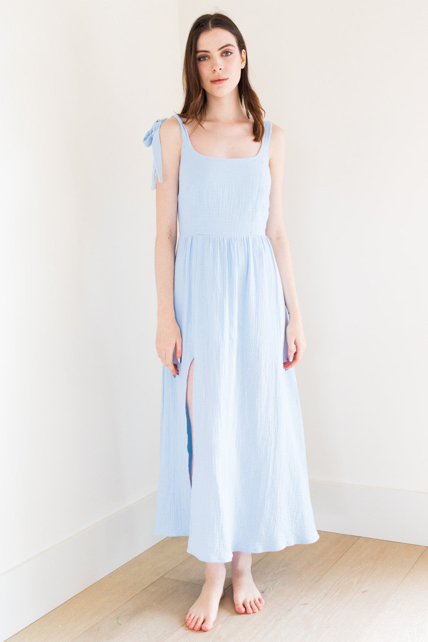This tie shoulder maxi dress features a thigh split for a touch of glamour, perfect for casual occasions. Made from a lightweight fabric, it's both comfortable and stylish. The tie shoulder detail adds a playful touch to this versatile dress, making it a must-have for your summer wardrobe.

