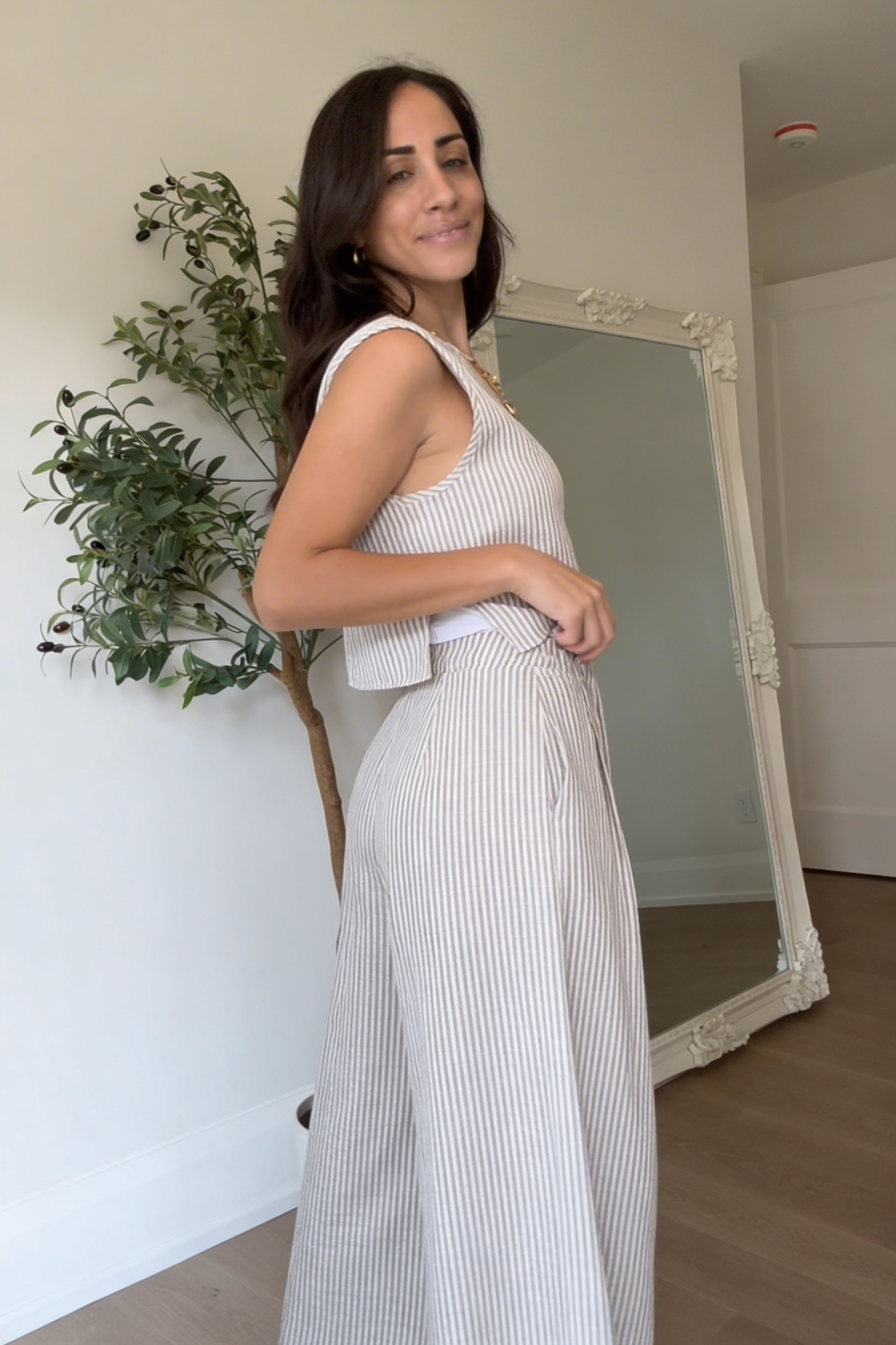 Woman wearing striped summer outfit styled with sandals