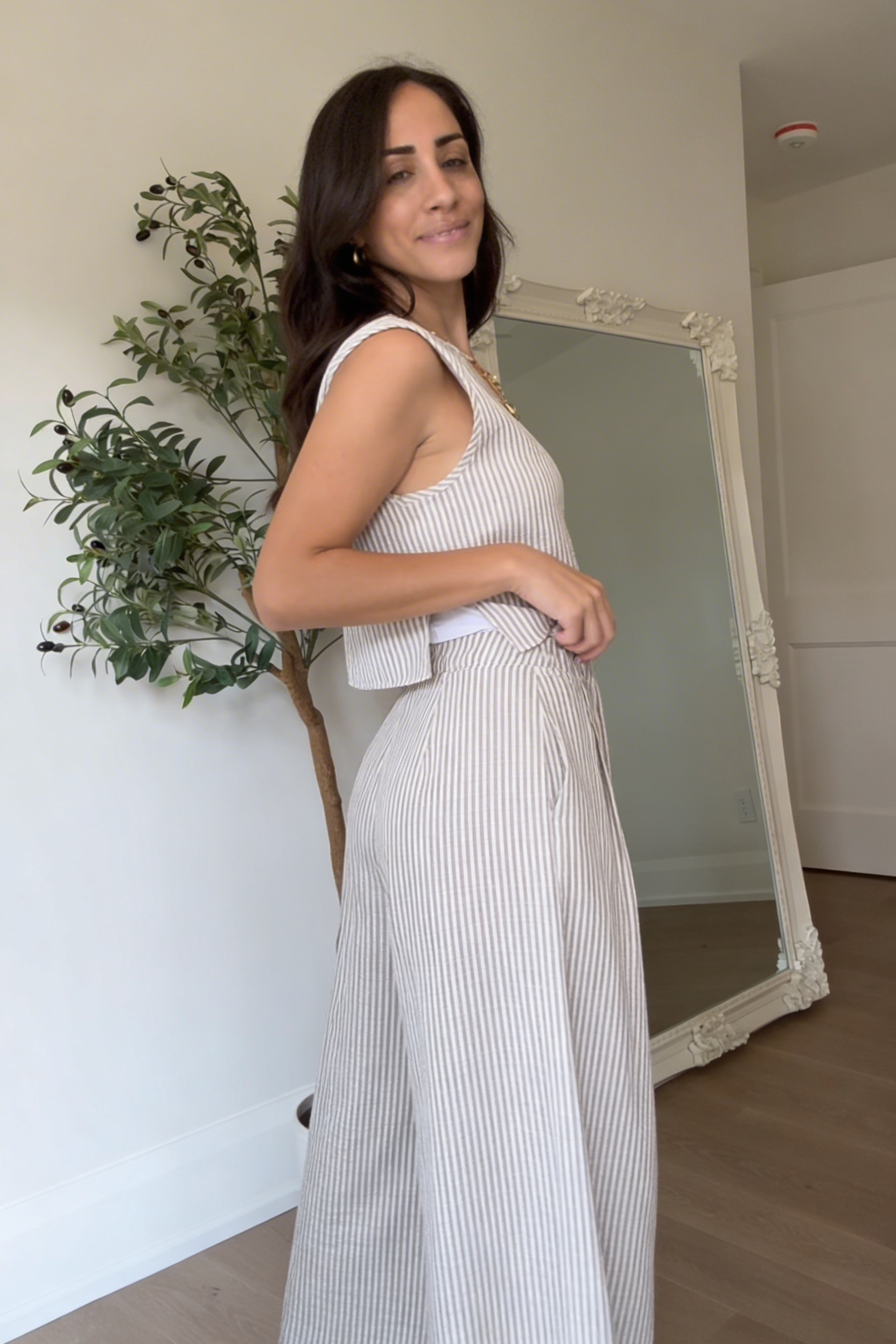 Woman wearing striped summer outfit styled with sandals