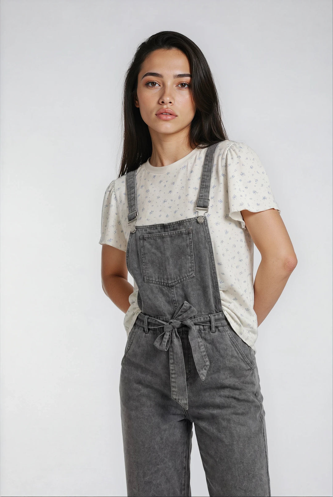 Floral cotton t shirt layered under grey overalls
