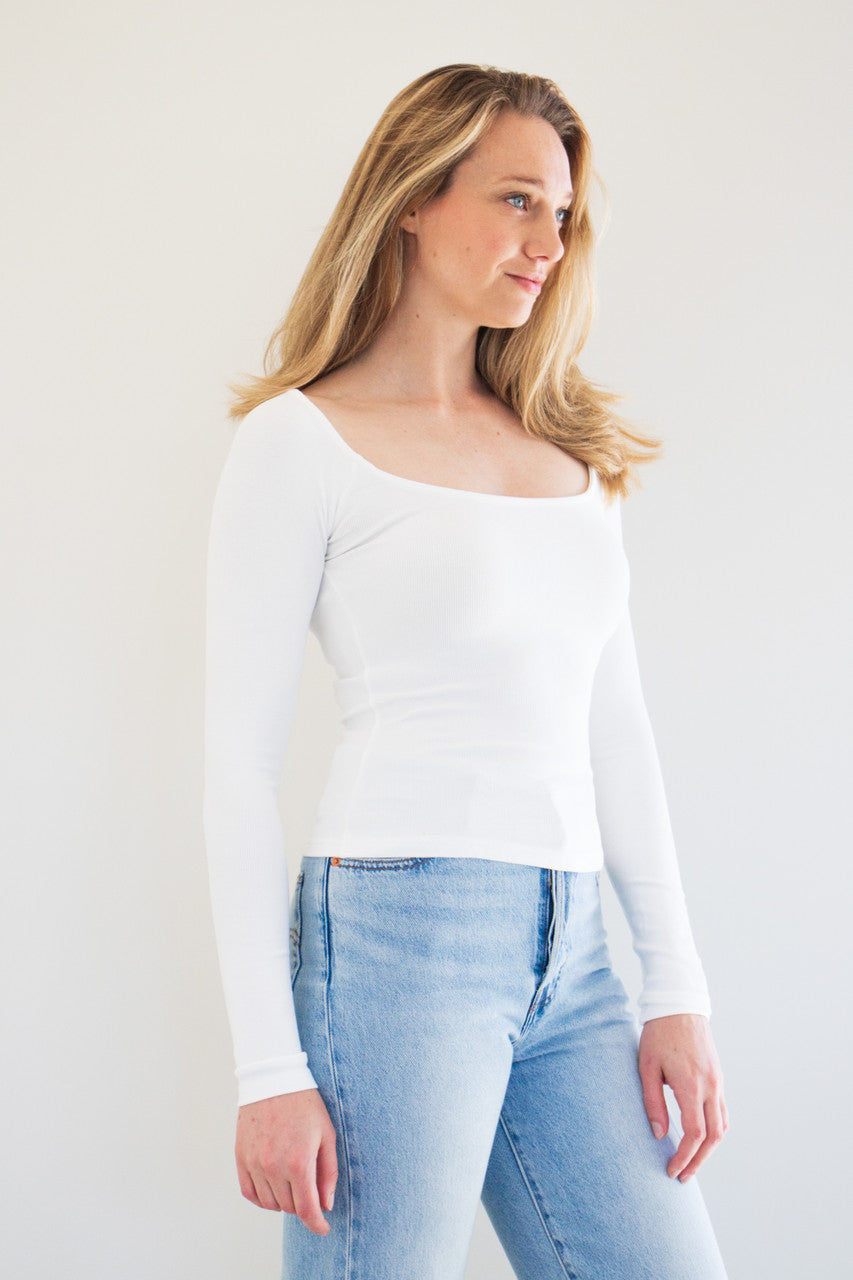 This versatile core basic top is made from a soft ribbed fabric which holds close against your figure, and a clean scoop neckline. A great building block for any outfit, we've paired this top with coats, overalls, and vests.

