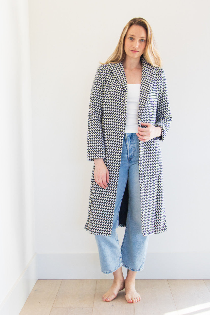 The Lily is a full body pocketed coat, lined with a silken interior and a gorgeous soft brush houndstooth finish. Striking and elegant, this highlight piece is a seasonal must-have. 

