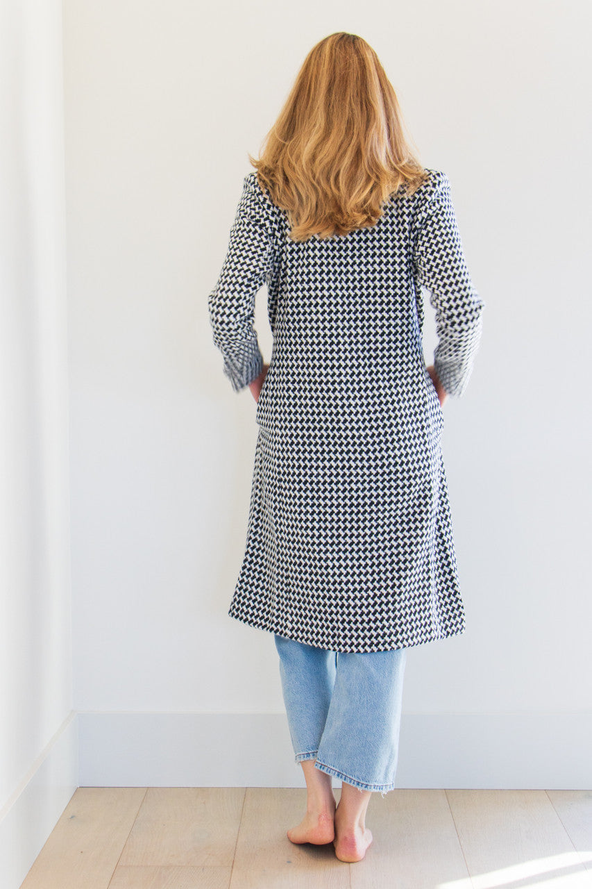 The Lily is a full body pocketed coat, lined with a silken interior and a gorgeous soft brush houndstooth finish. Striking and elegant, this highlight piece is a seasonal must-have. 

