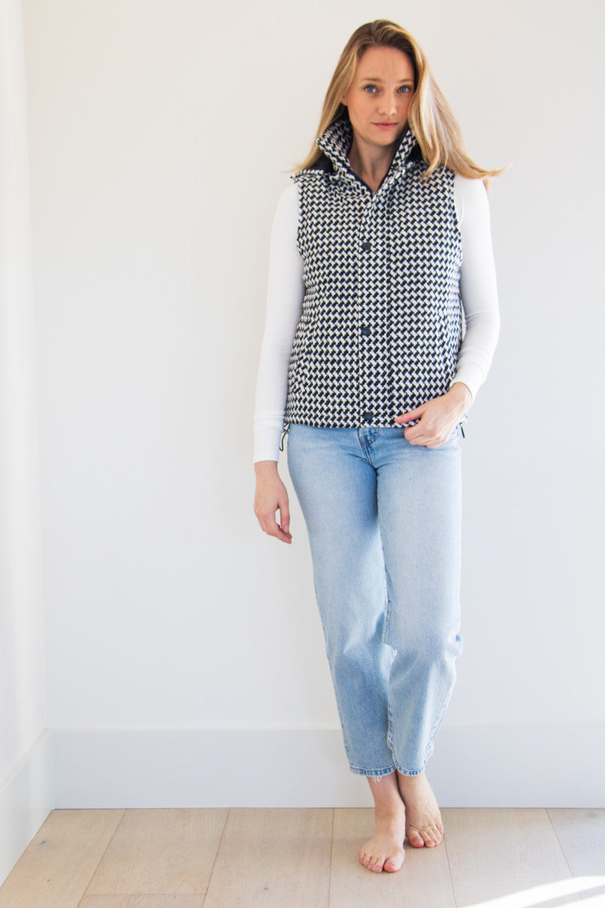 The Lina Vest is a waist length pocketed vest, lined with a silken interior and a gorgeous soft brush houndstooth finish. Create your perfect fit with adjustable cinches on both sides and a dual zipper and button closure. Striking and elegant, this highlight piece is a seasonal must-have. 

