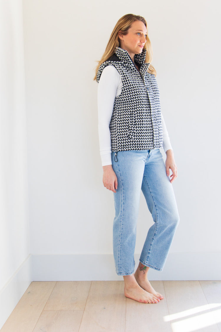 The Lina Vest is a waist length pocketed vest, lined with a silken interior and a gorgeous soft brush houndstooth finish. Create your perfect fit with adjustable cinches on both sides and a dual zipper and button closure. Striking and elegant, this highlight piece is a seasonal must-have. 

