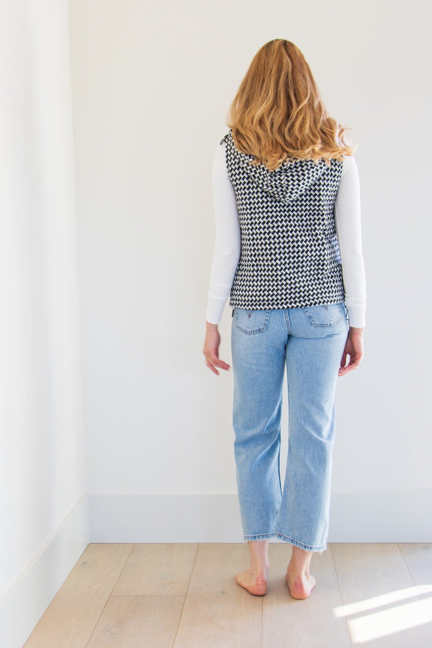 The Lina Vest is a waist length pocketed vest, lined with a silken interior and a gorgeous soft brush houndstooth finish. Create your perfect fit with adjustable cinches on both sides and a dual zipper and button closure. Striking and elegant, this highlight piece is a seasonal must-have. 

