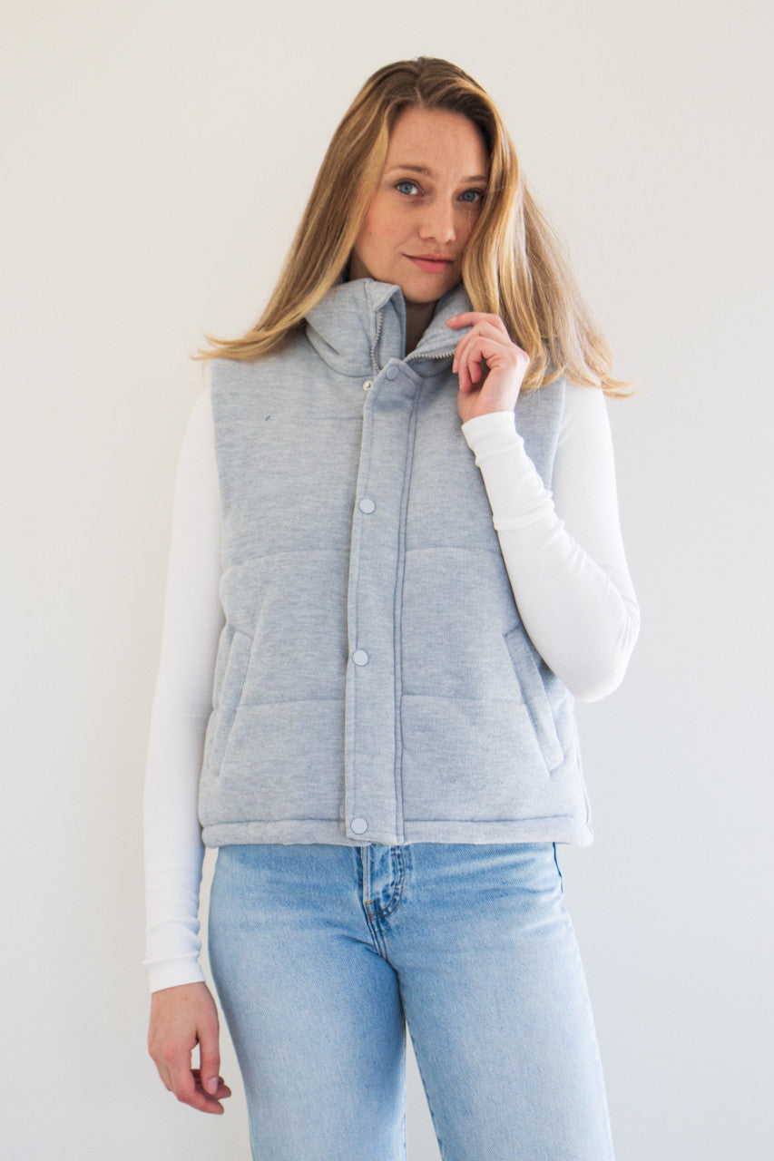 Transition into the cold with The Cora Knit Puffer Vest. Featuring plush fabric, a high-neck rise, and slightly cropped fit, this is not your average winter vest. Available in earthy natural tones Grey, Oat Milk, and Black. 

