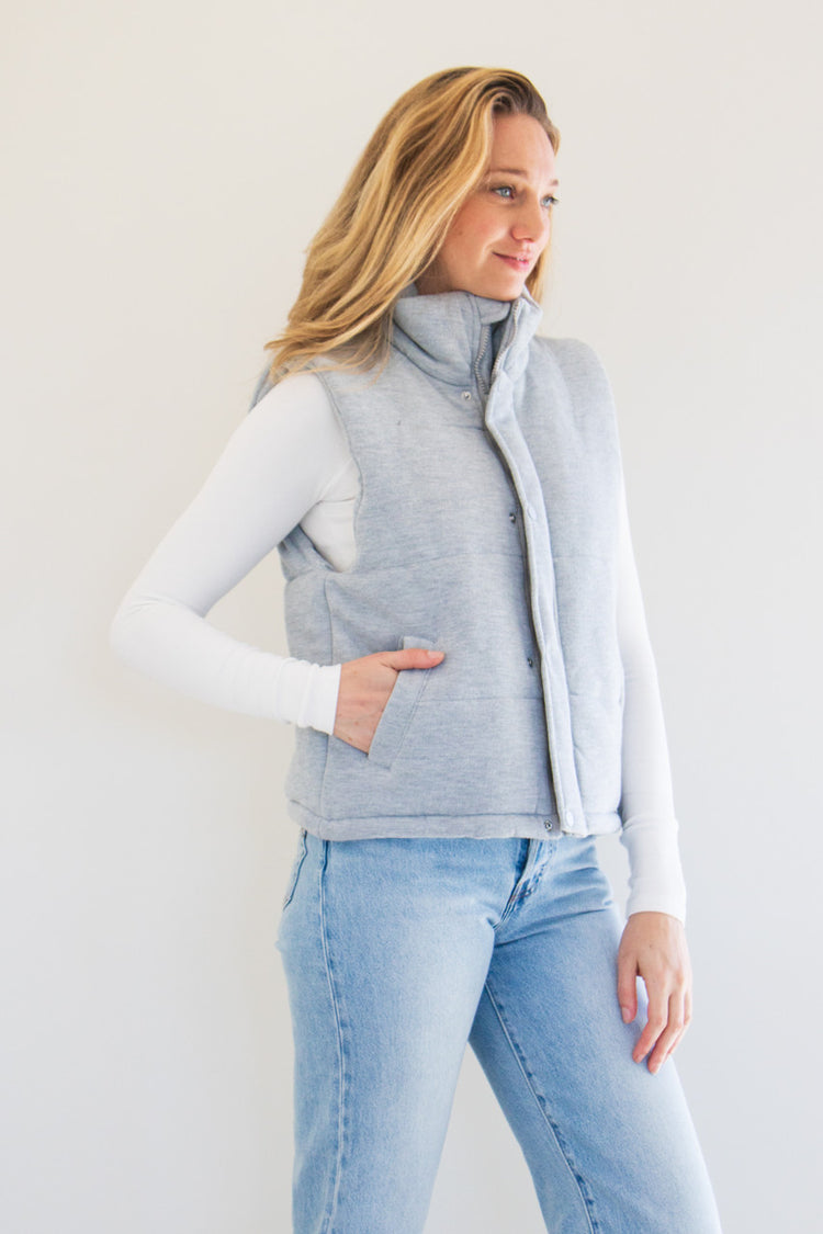 Transition into the cold with The Cora Knit Puffer Vest. Featuring plush fabric, a high-neck rise, and slightly cropped fit, this is not your average winter vest. Available in earthy natural tones Grey, Oat Milk, and Black. 

