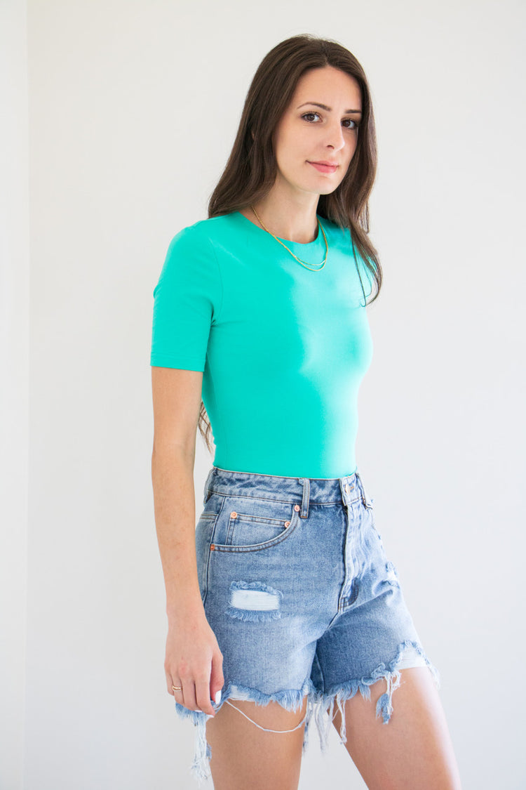 An essential bodysuit with a close fit and lightweight fabric, Pavani features a solid and smooth finish with a crew cut neckline, tee sleeve and just a little bit of stretch.

