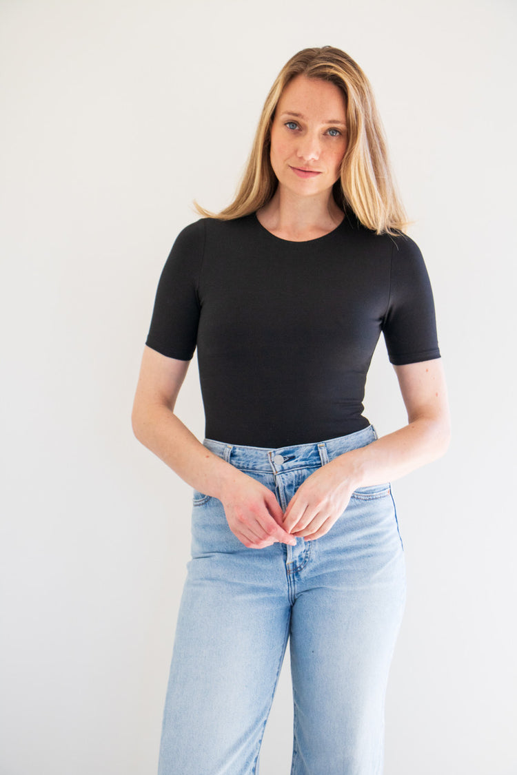 An essential bodysuit with a close fit and lightweight fabric, Pavani features a solid and smooth finish with a crew cut neckline, tee sleeve and just a little bit of stretch.

