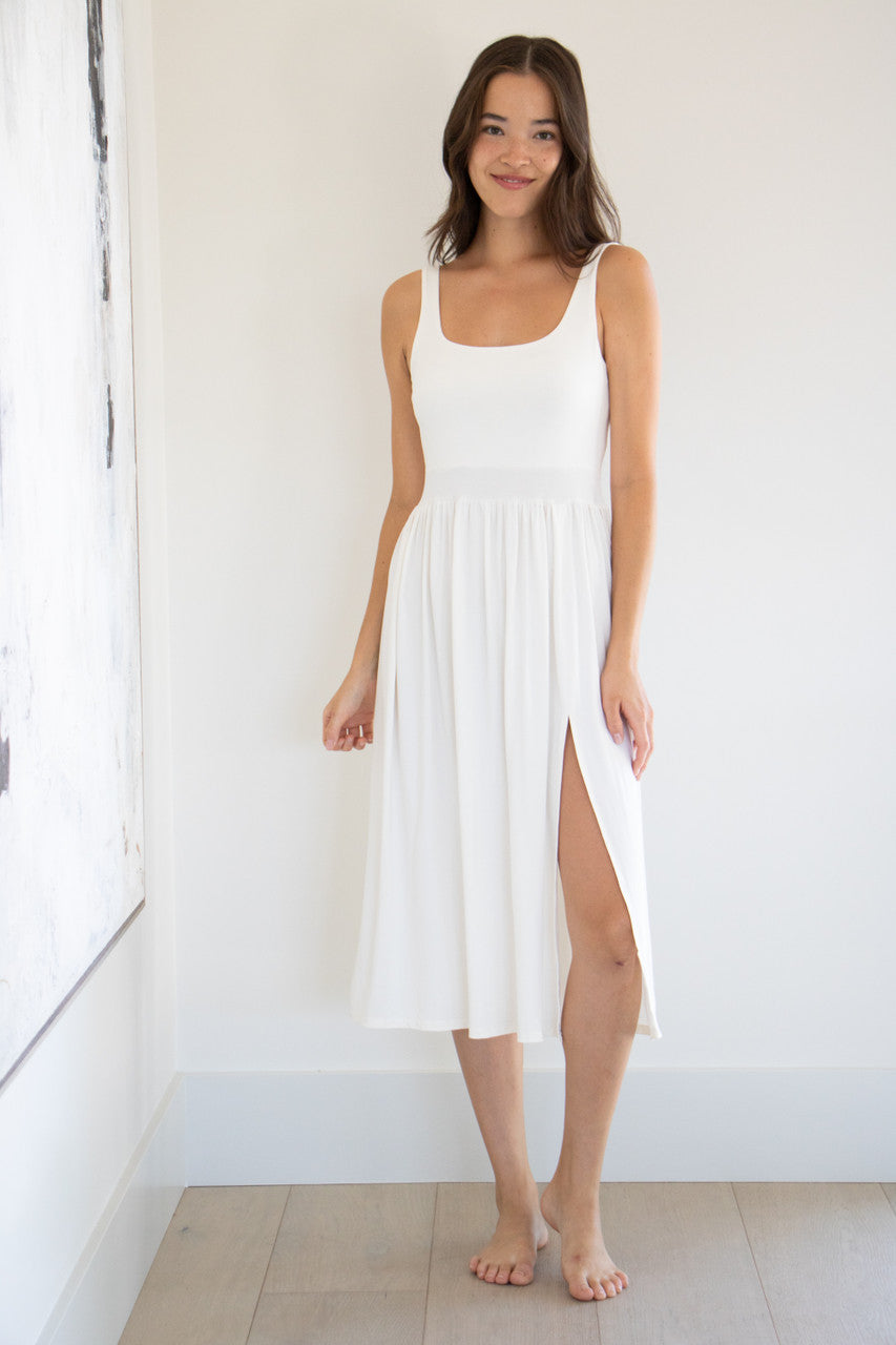 Our best selling summer dress is back in five seasonal colours. Made with a flattering silhouette and scooped neckline, the perfect amount of stretch and a side split to mid thigh. Viscose based fabric has a soft, flowing quality - easy to wear casually and effortless to elevate for something more formal. 
