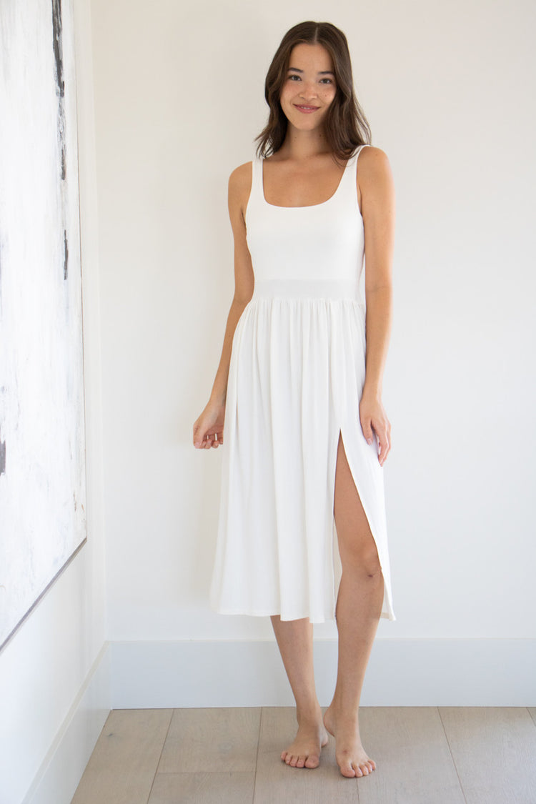 Our best selling summer dress is back in five seasonal colours. Made with a flattering silhouette and scooped neckline, the perfect amount of stretch and a side split to mid thigh. Viscose based fabric has a soft, flowing quality - easy to wear casually and effortless to elevate for something more formal. 
