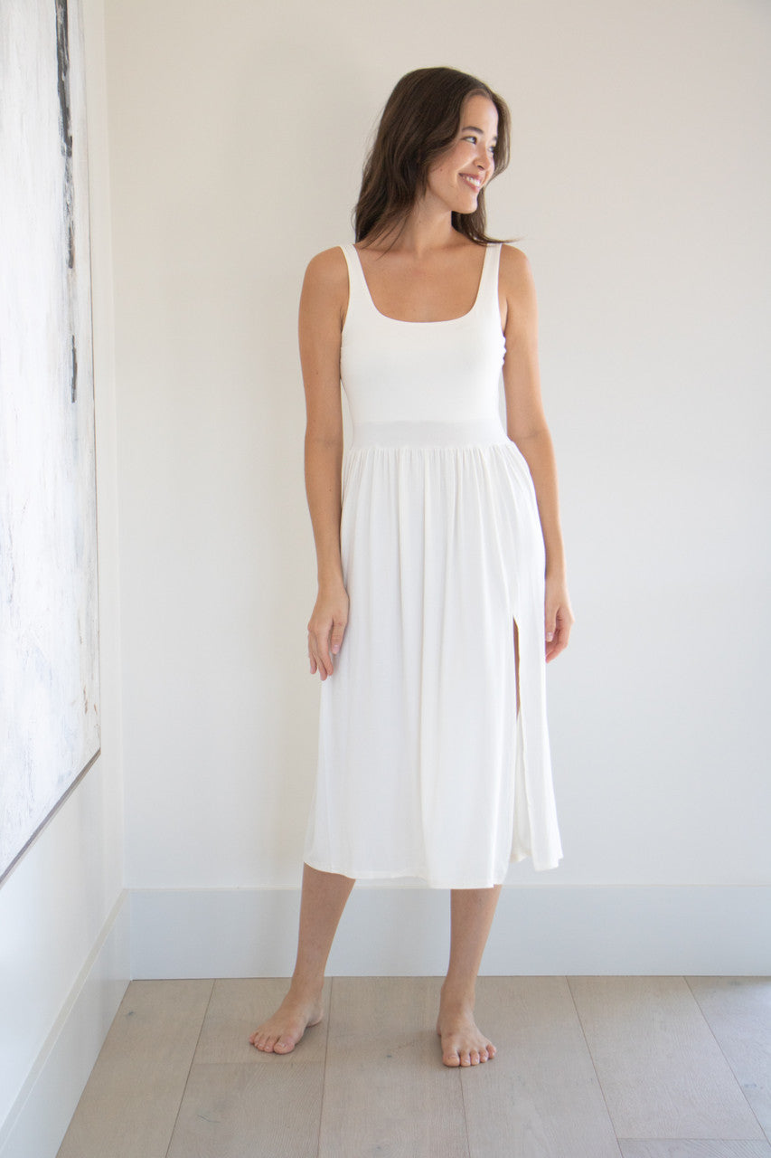 Our best selling summer dress is back in five seasonal colours. Made with a flattering silhouette and scooped neckline, the perfect amount of stretch and a side split to mid thigh. Viscose based fabric has a soft, flowing quality - easy to wear casually and effortless to elevate for something more formal. 
