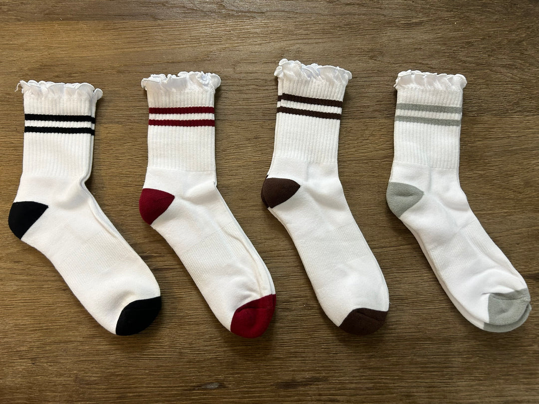 PRIV Stripe Ruffle Top Socks flat lay in Black, Wine, Espresso and Grey – white ribbed crew sock with ruffle cuff and two stripes
