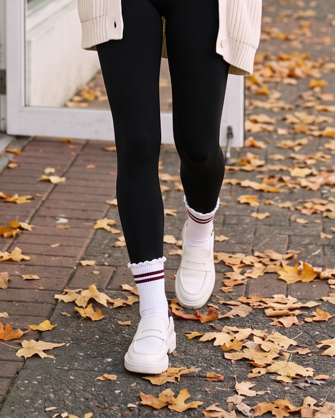 Stripe Ruffle Top Socks in Wine worn with white sneakers on an autumn sidewalk – PRIV