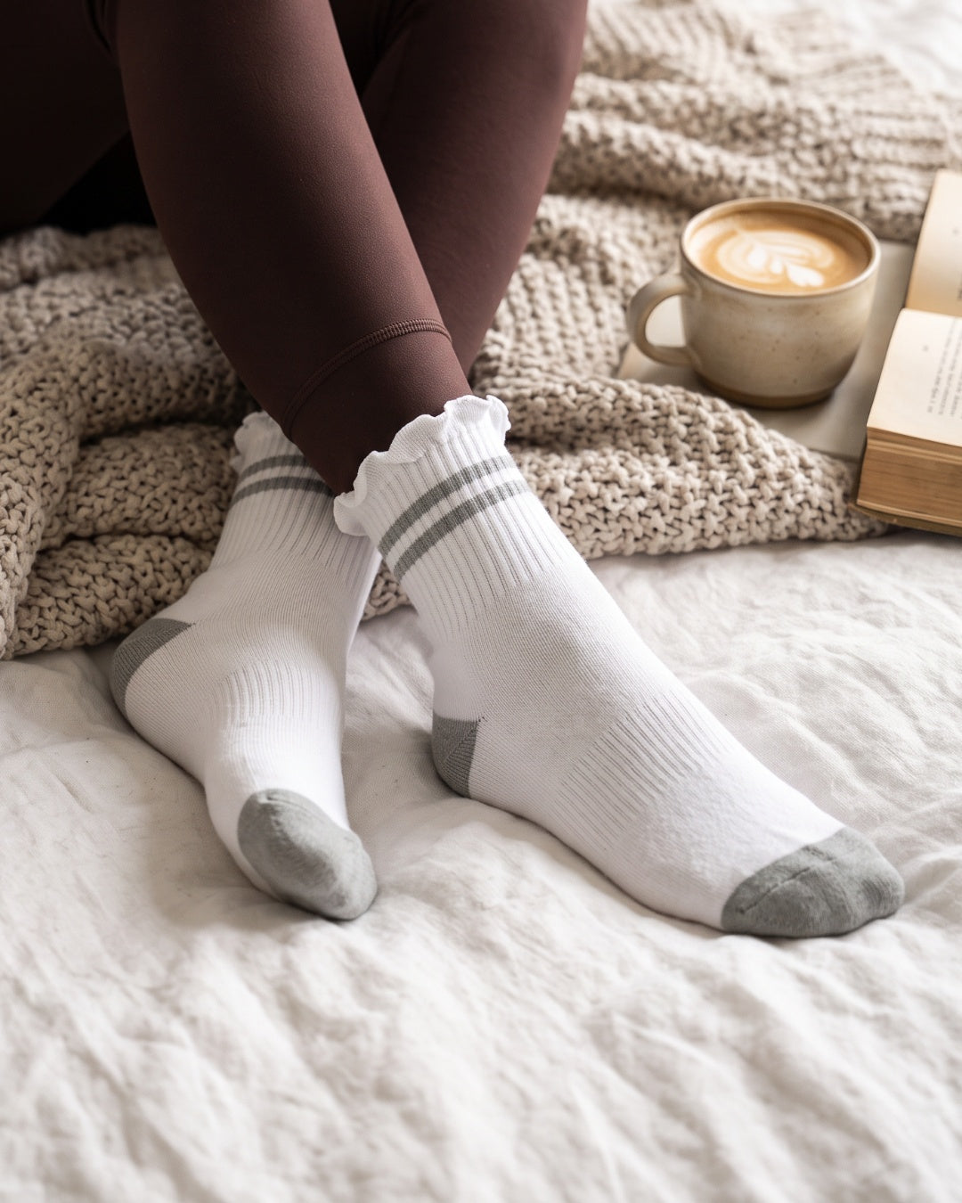 Stripe Ruffle Top Socks in Grey lounging in bed – PRIV