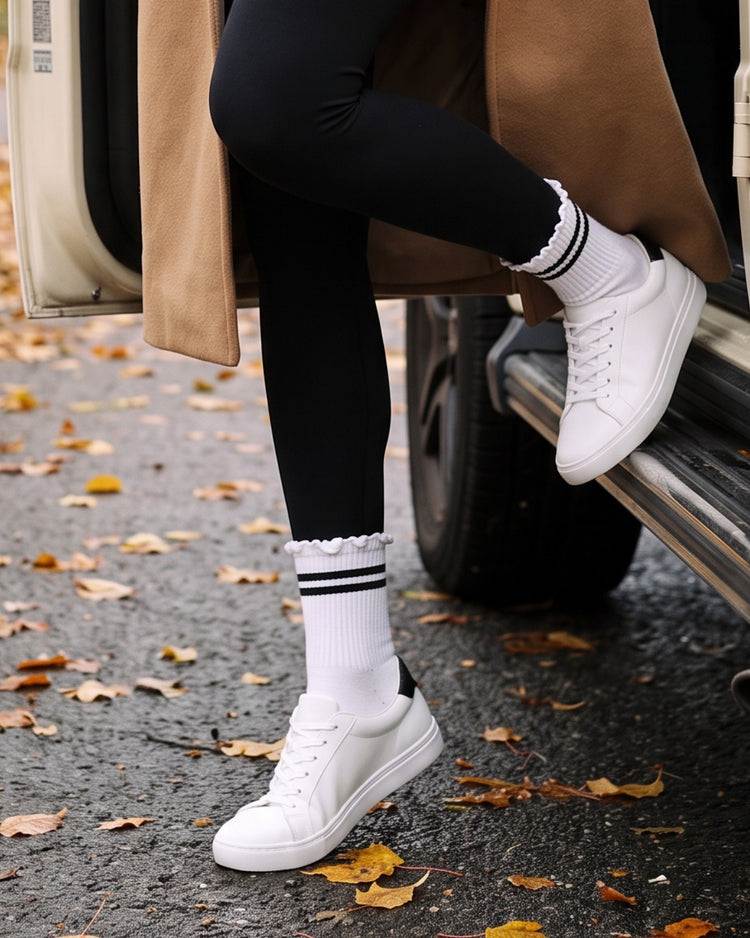 Stripe Ruffle Top Socks in Black worn with white sneakers on a fall street – PRIV